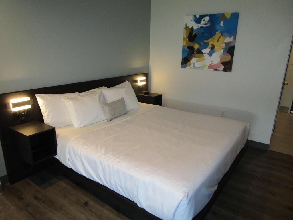 Premium bedding, desk, laptop workspace, iron/ironing board