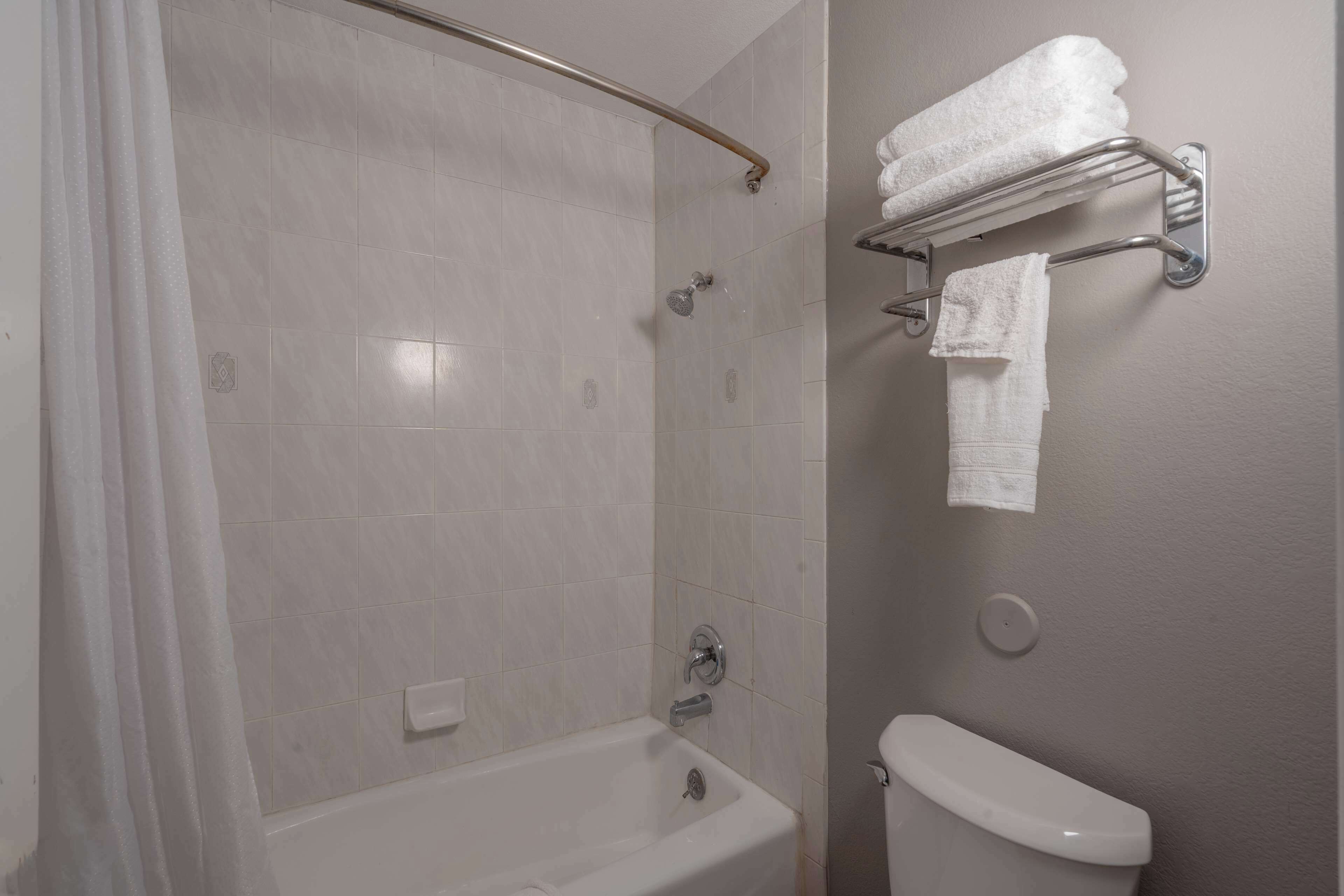 A bathroom with a bathtub, a shower, and a toilet.