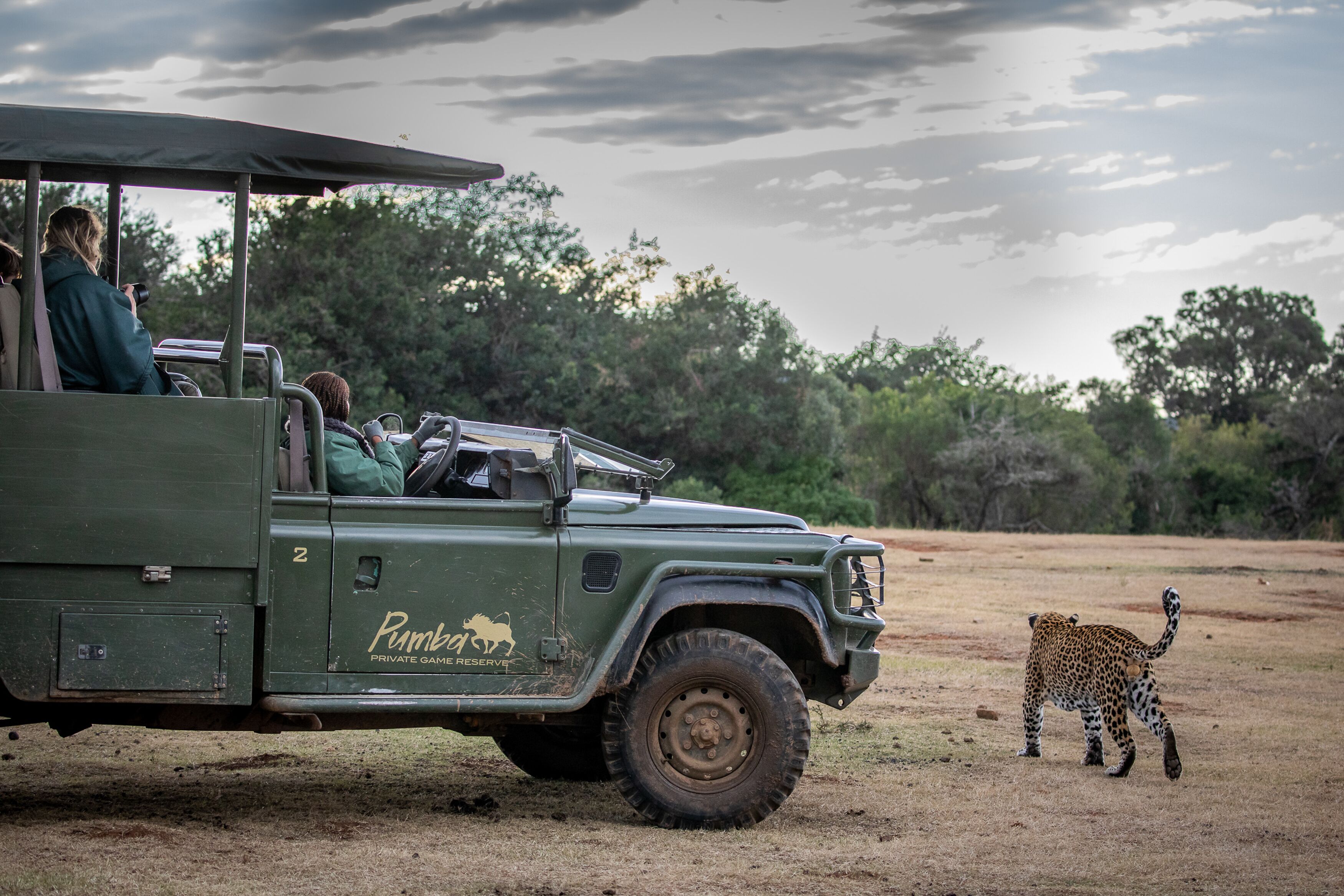 A safari vehicle with a logo and text indicating a private game reserve.