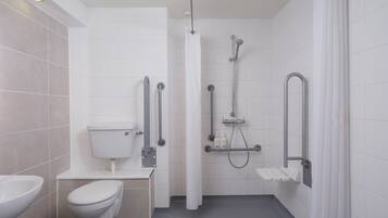 A modern bathroom with a toilet, bidet, and shower.