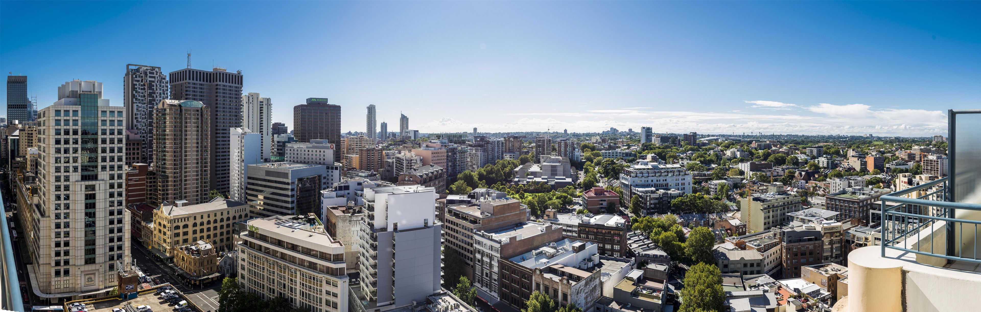 A cityscape with a variety of building styles and a clear sky.