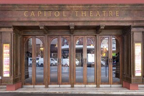 The entrance to the Capitol Theatre with a classic design, featuring a large arched doorway and decorative columns. - Oaks Sydney Castlereagh Suites (Haymarket)