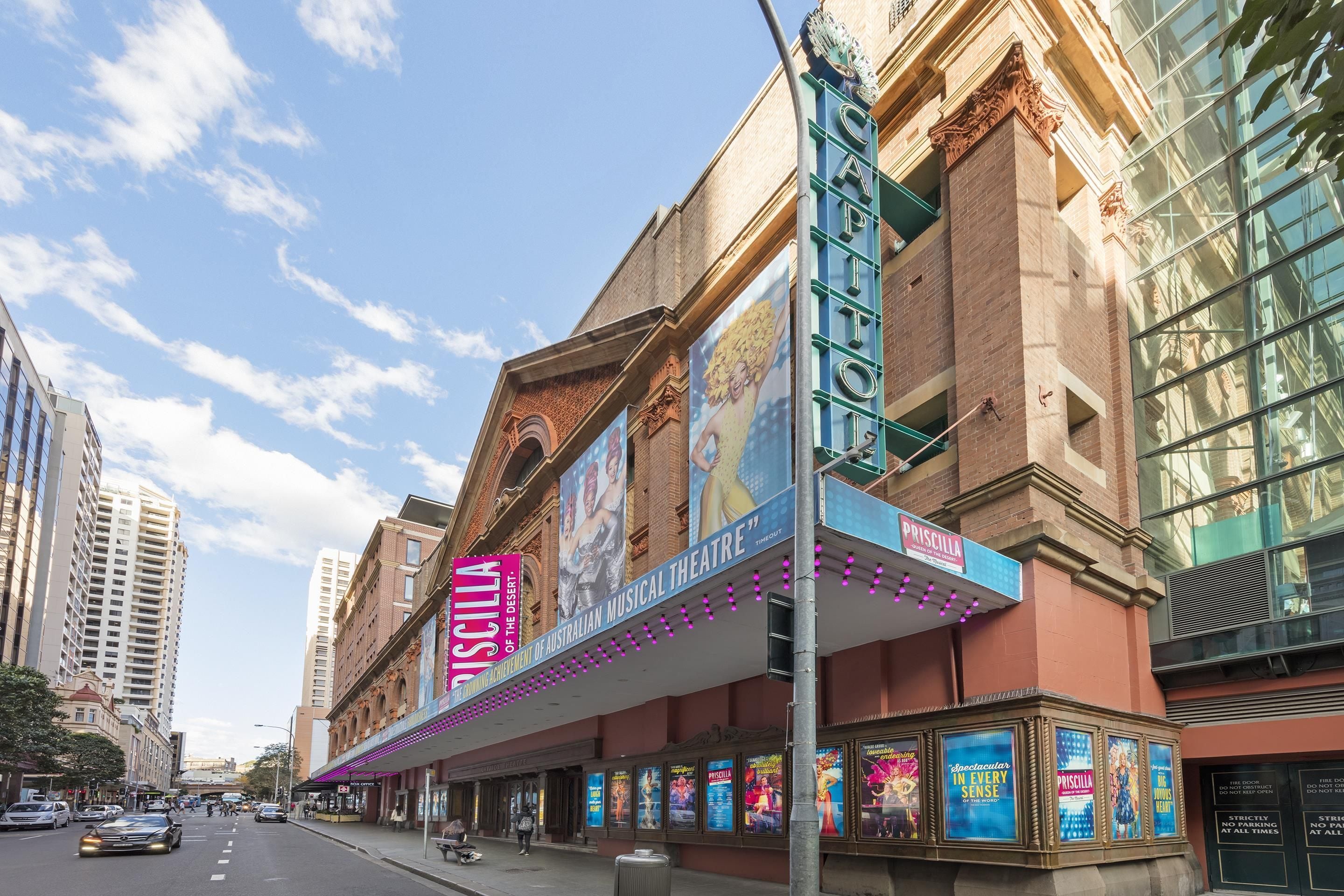 A theater building with a marquee advertising 'Priscilla.'