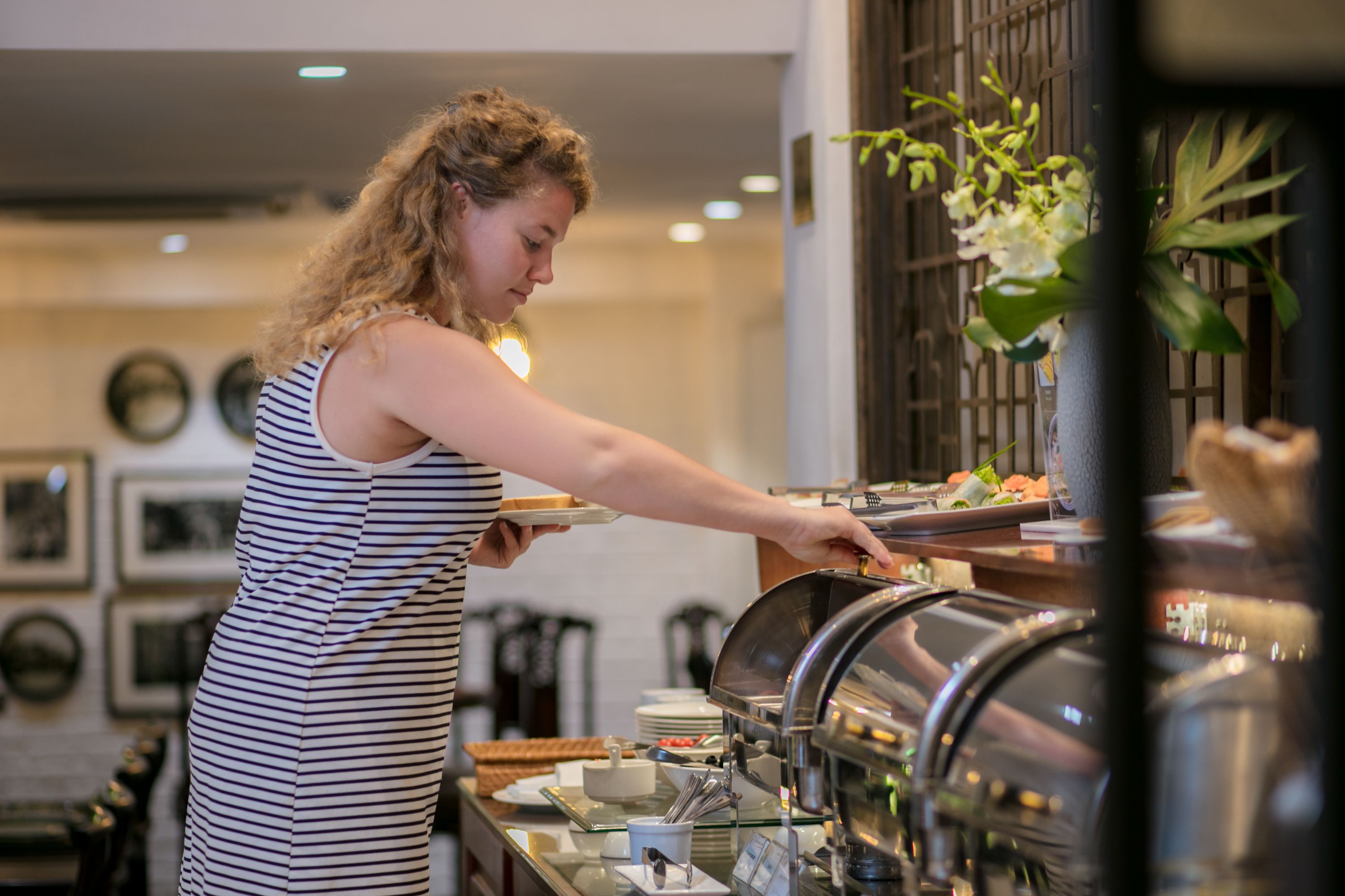 A buffet setup with a variety of food items and a buffet server.