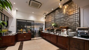 A modern kitchen with marble flooring, wooden cabinets, and a buffet setup. - Hong Ngoc Dynastie Boutique Hotel & Spa (Hanoi)