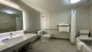 A modern bathroom with a large mirror, a sink, a toilet, and a shower area. - Holiday Inn Express & Suites Somerset Central by IHG (Somerset)