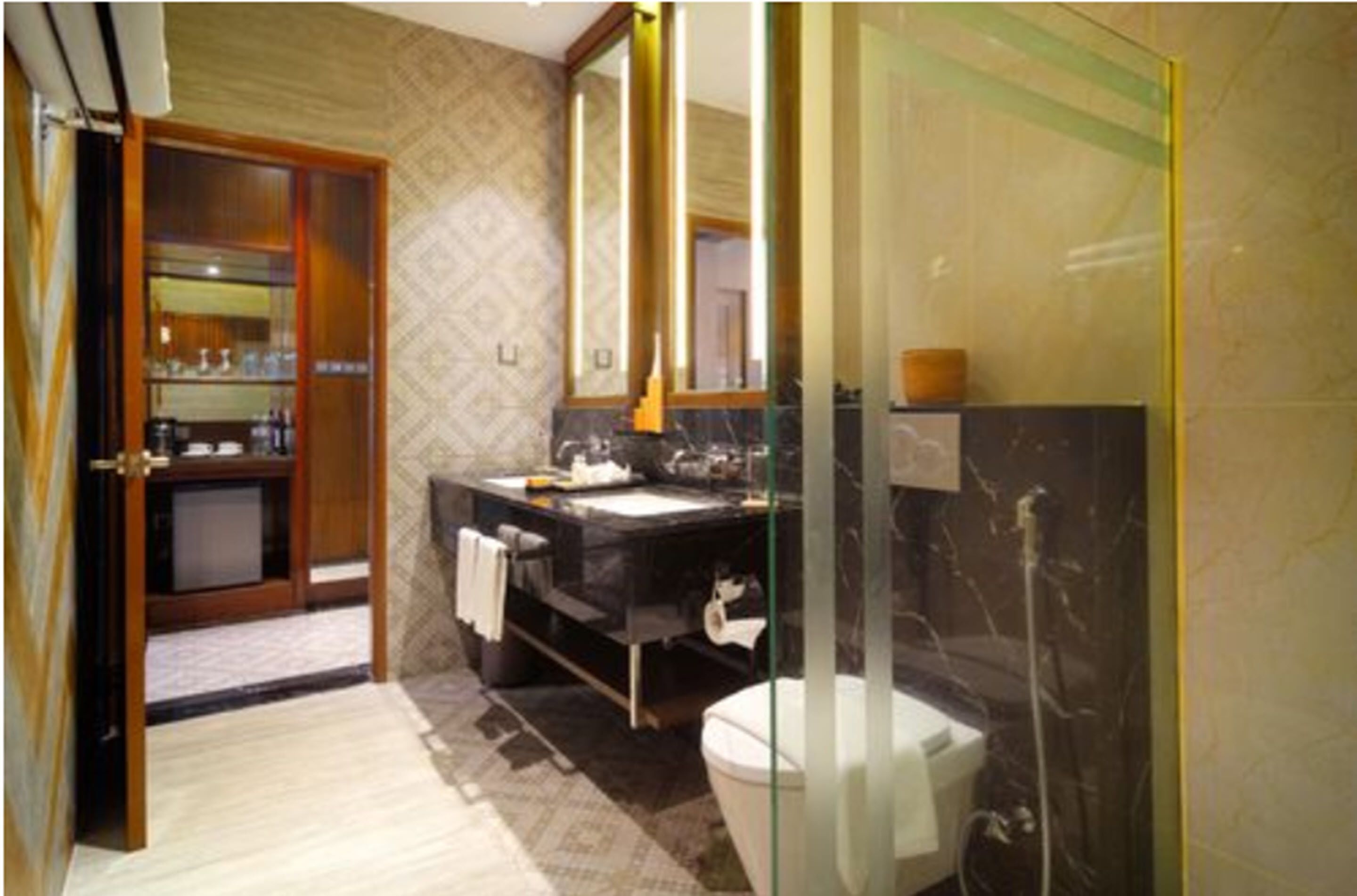 A bathroom with a glass shower enclosure, a sink with a mirror, and a toilet.
