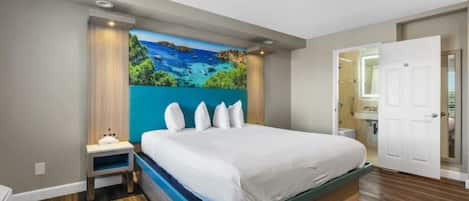 A bedroom with a bed, nightstand, and a painting on the wall.