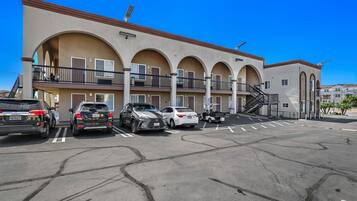 A multi-story building with a parking lot.