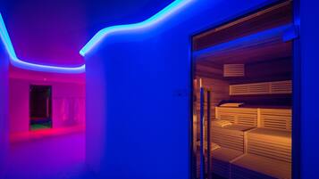 A modern room with a glass partition, a wooden bench, and a neon light strip along the ceiling.
