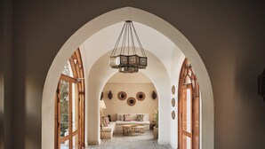 A hallway with checkered flooring, an arched ceiling, and a central seating area with a table and chairs. - Ali Pasha Hotel El Gouna (El Gouna)