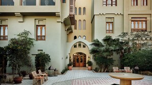 A courtyard with a fountain, tiled floor, potted plants, and outdoor seating. - Ali Pasha Hotel El Gouna (El Gouna)