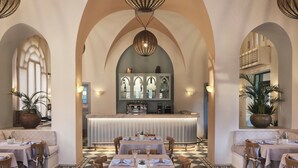 A spacious dining area with high arched ceilings, a central bar, and checkered flooring. - Ali Pasha Hotel El Gouna (El Gouna)