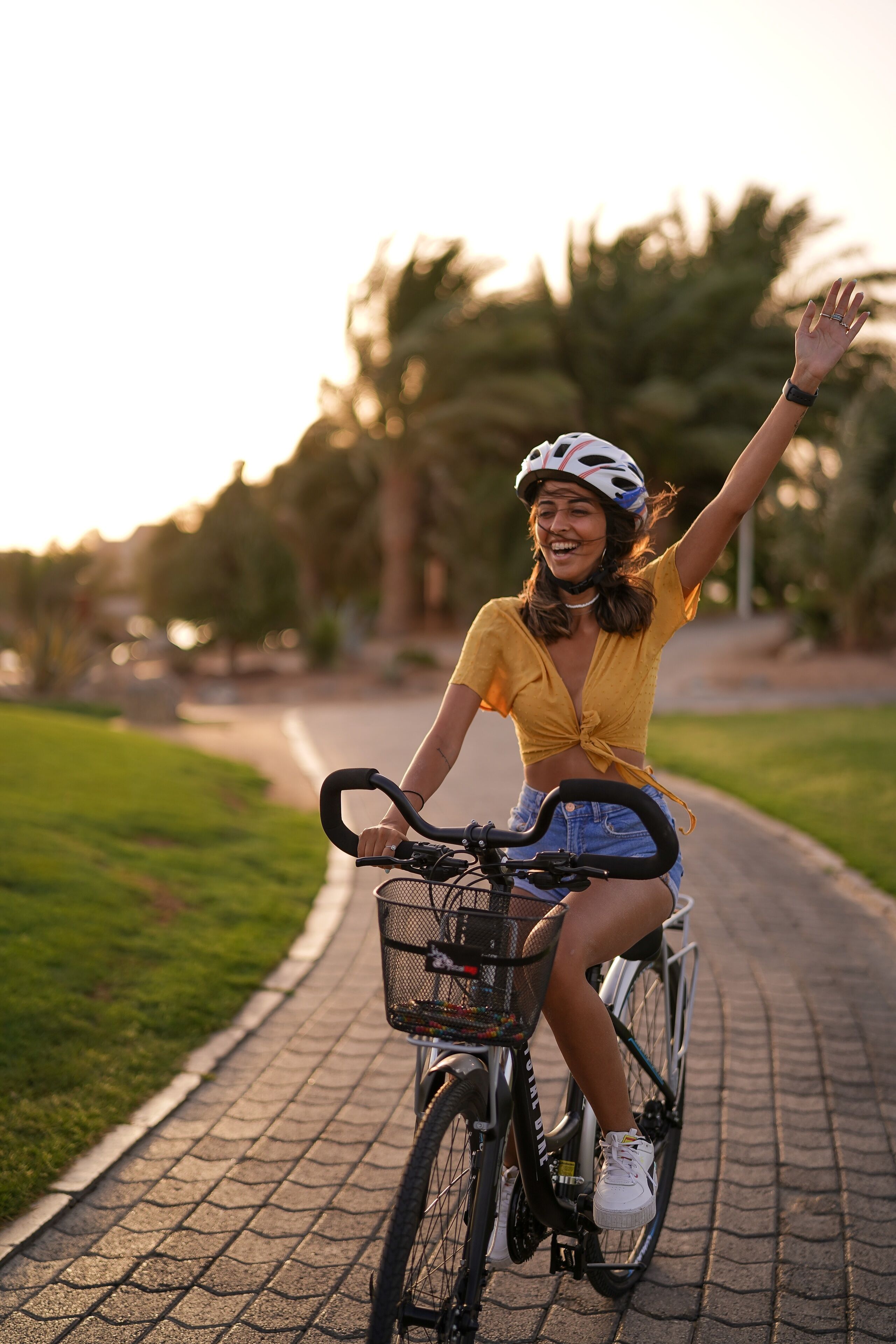 A person riding a bicycle on a paved path.