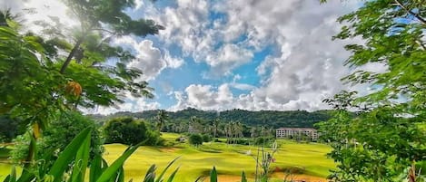A golf course with a building in the background.