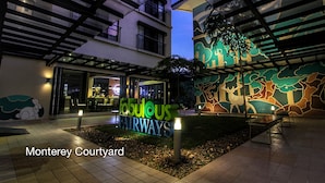 A courtyard with a sign reading "Fabulous Fairways," benches, and a mural.