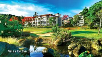 Villas situated by a golf course with views of the surrounding landscape and well-manicured lawns.