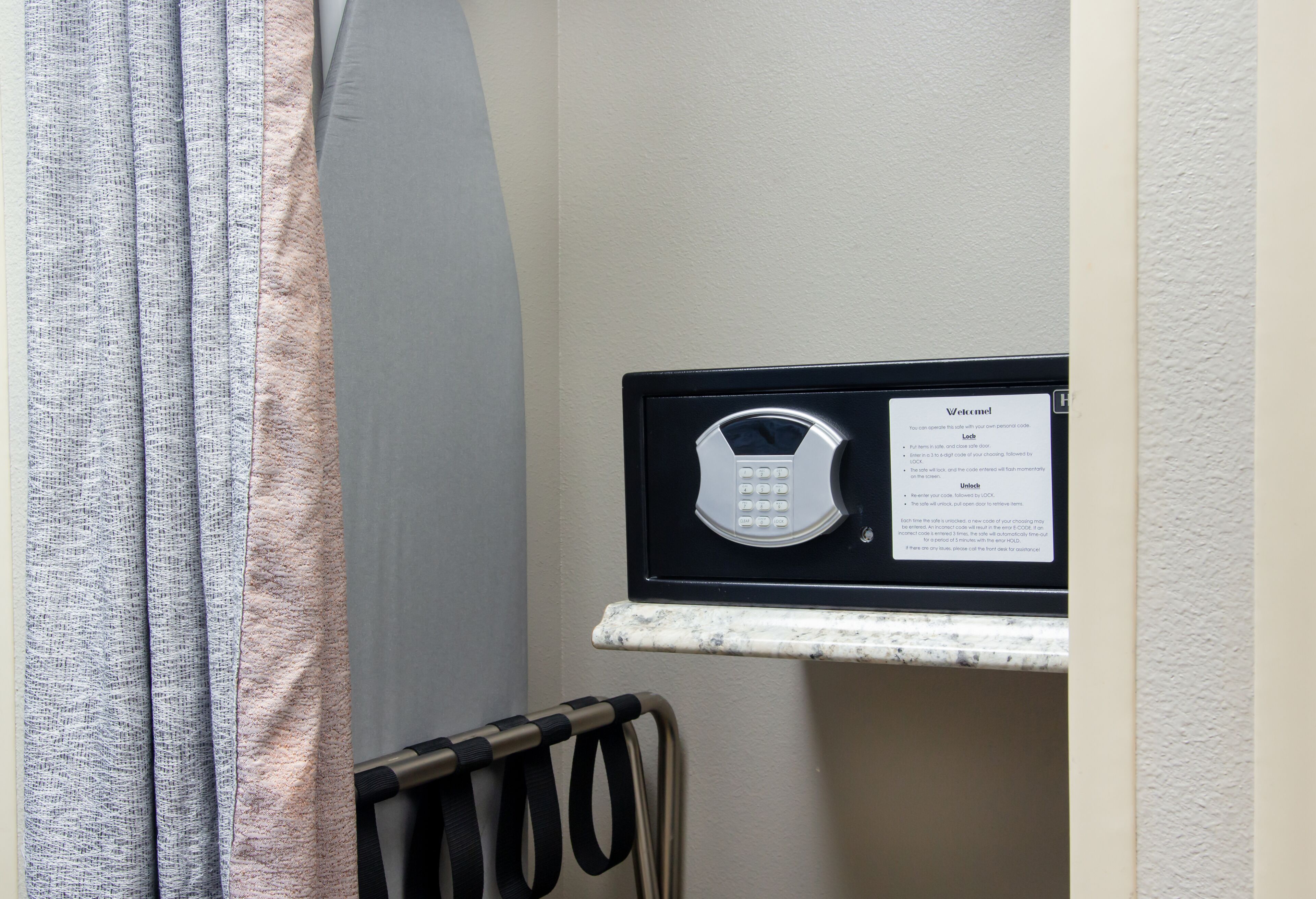 A room with a wall-mounted intercom system and a metal radiator.