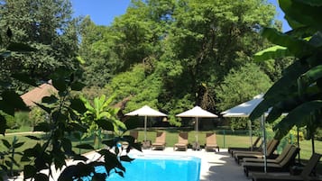 Seasonal outdoor pool, open 9:00 AM to 8:00 PM, pool umbrellas