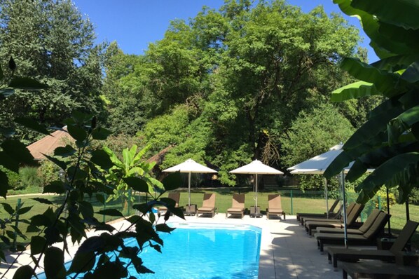Seasonal outdoor pool, open 9:00 AM to 8:00 PM, pool umbrellas