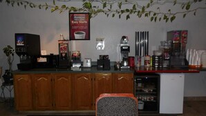 A kitchenette with a coffee maker, toaster, and refrigerator. - American Inn & Suites (Boone)