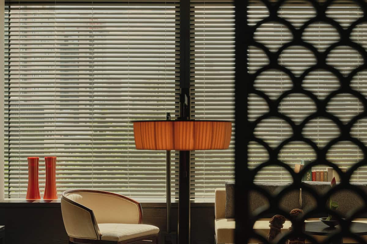 A modern room with a large window, a round table, and two chairs.
