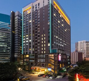 A multi-story hotel with a modern design, featuring a prominent entrance with a covered area and visible signage. - Good International Hotel (Guangzhou)