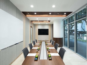 A conference room with a long table, chairs, a whiteboard, and a large window. - ibis Singapore On Bencoolen (Singapore)