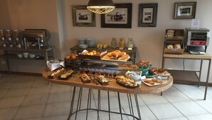 A buffet with various food items and a coffee station. - Sol Arrayan Hotel & Spa (Villa La Angostura)