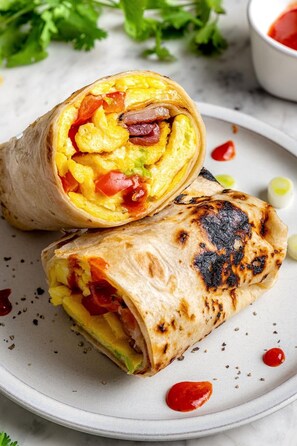 A burrito cut in half on a plate, revealing its fillings. - Four Points by Sheraton Ontario-Rancho Cucamonga (Rancho Cucamonga)