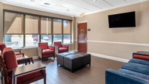 A hotel lobby with seating areas, a flat-screen TV, and large windows. - Comfort Inn & Suites Fort Walton Beach - Destin West (Fort Walton Beach)