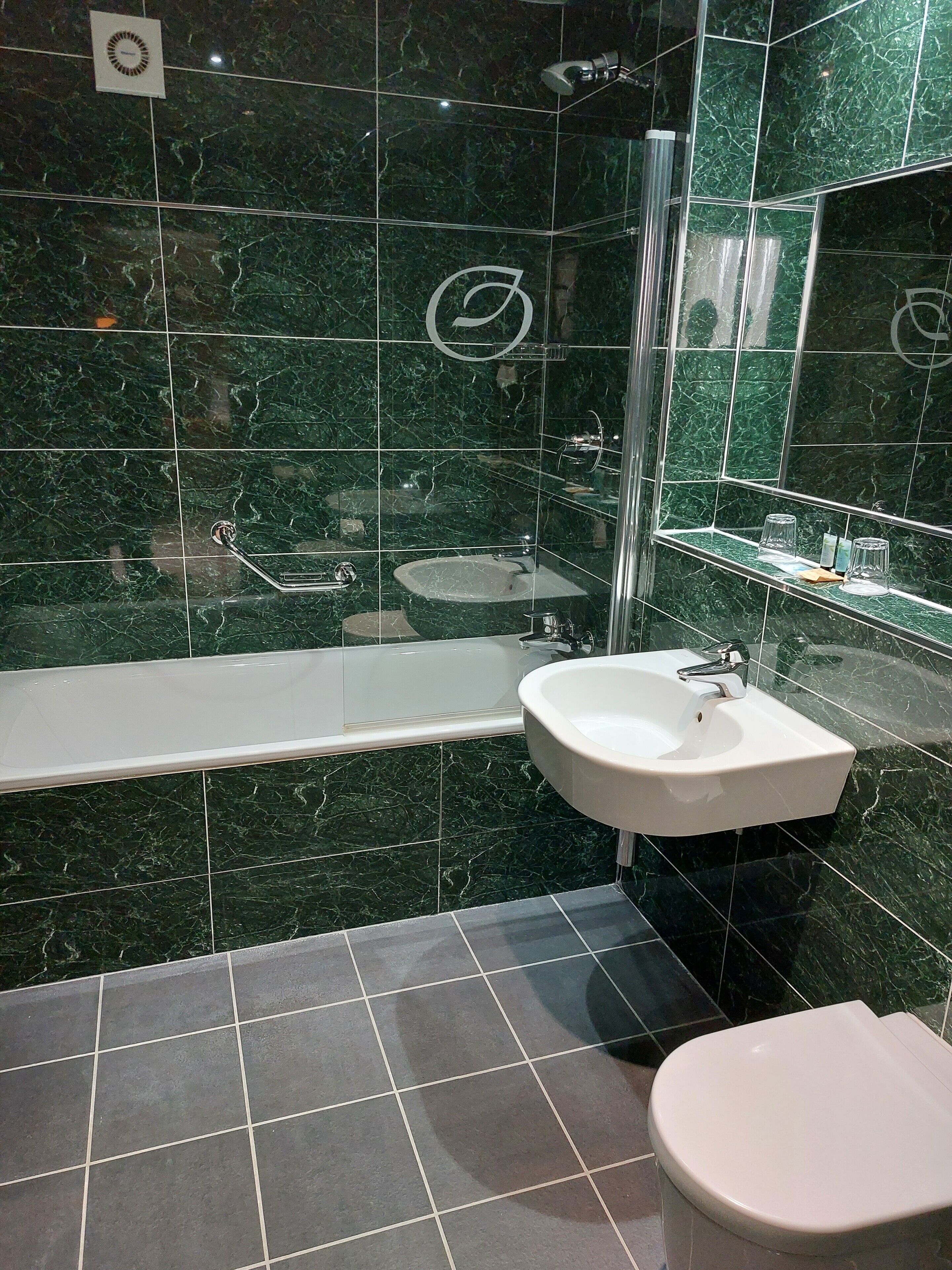 A bathroom with a bathtub, a sink, and a toilet.