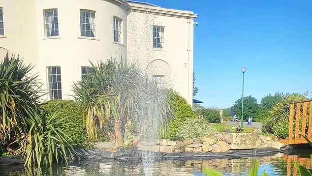 A building with a fountain in a garden. - Owston Hall Hotel (Doncaster)