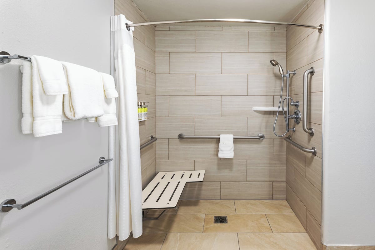 separate bathtub and shower, deep-soaking bathtub, hair dryer, towels