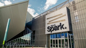 A modern building with a prominent sign reading "TELUS Spark."