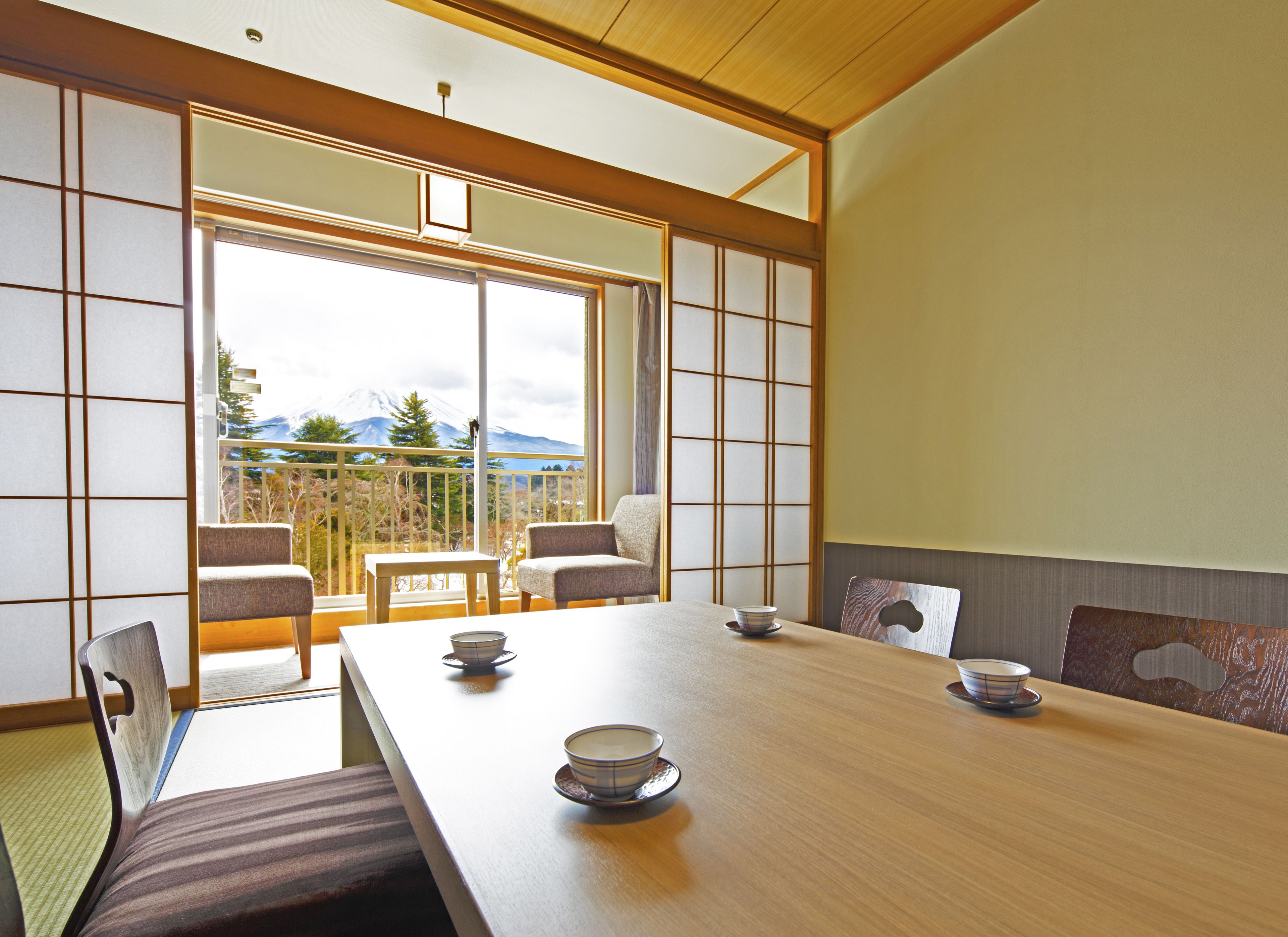 A traditional Japanese room with tatami flooring, a low wooden table, and sliding shoji doors.