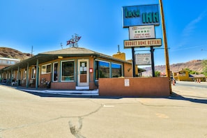 A small, single-story building with a sign for 'Inn Inn' and a 'Budget Done Better!' slogan.