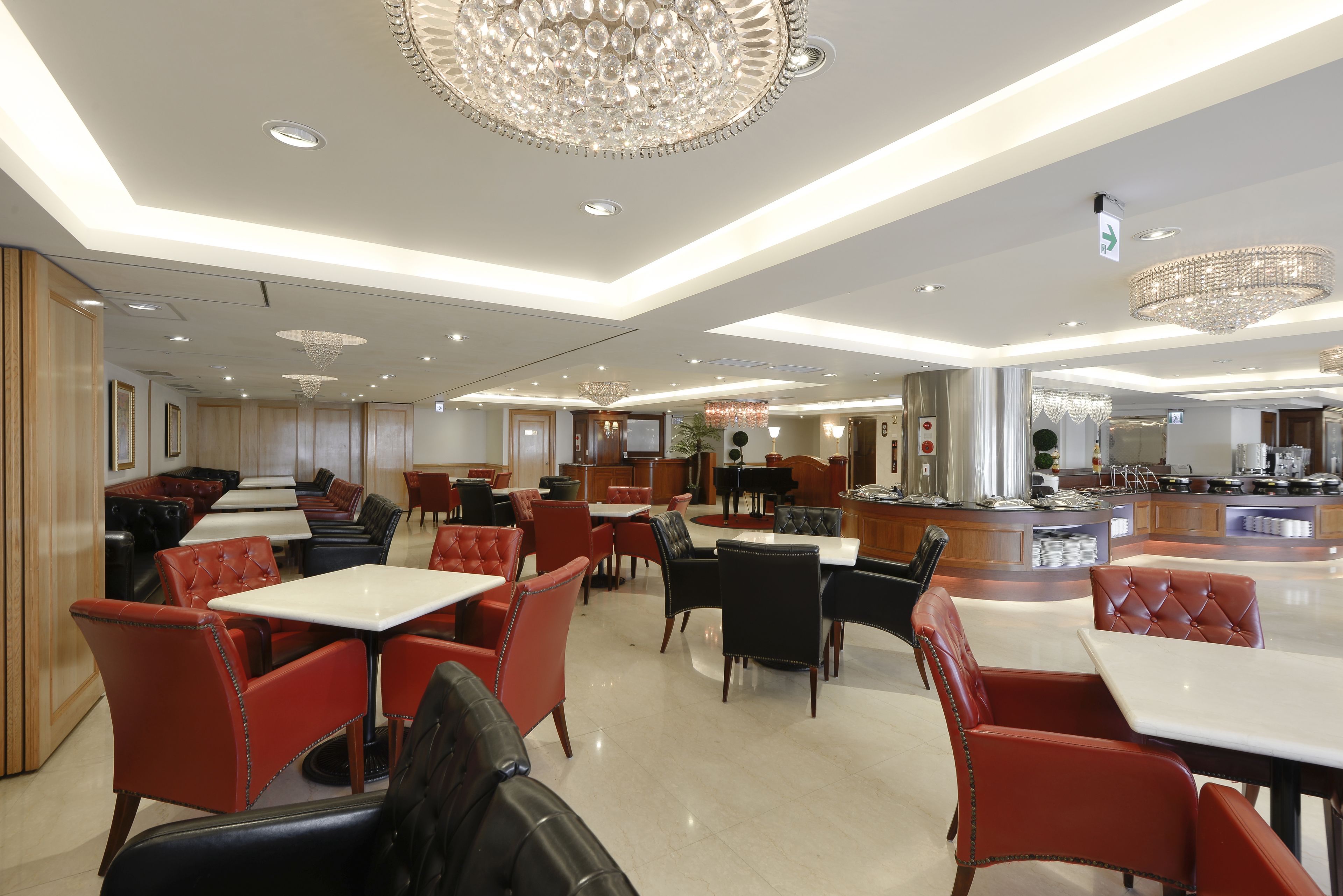 A spacious restaurant with multiple seating areas, including booths and tables.