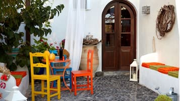 Enjoy an outdoor seating area with a small table and two chairs, a wooden barrel, and a lantern.