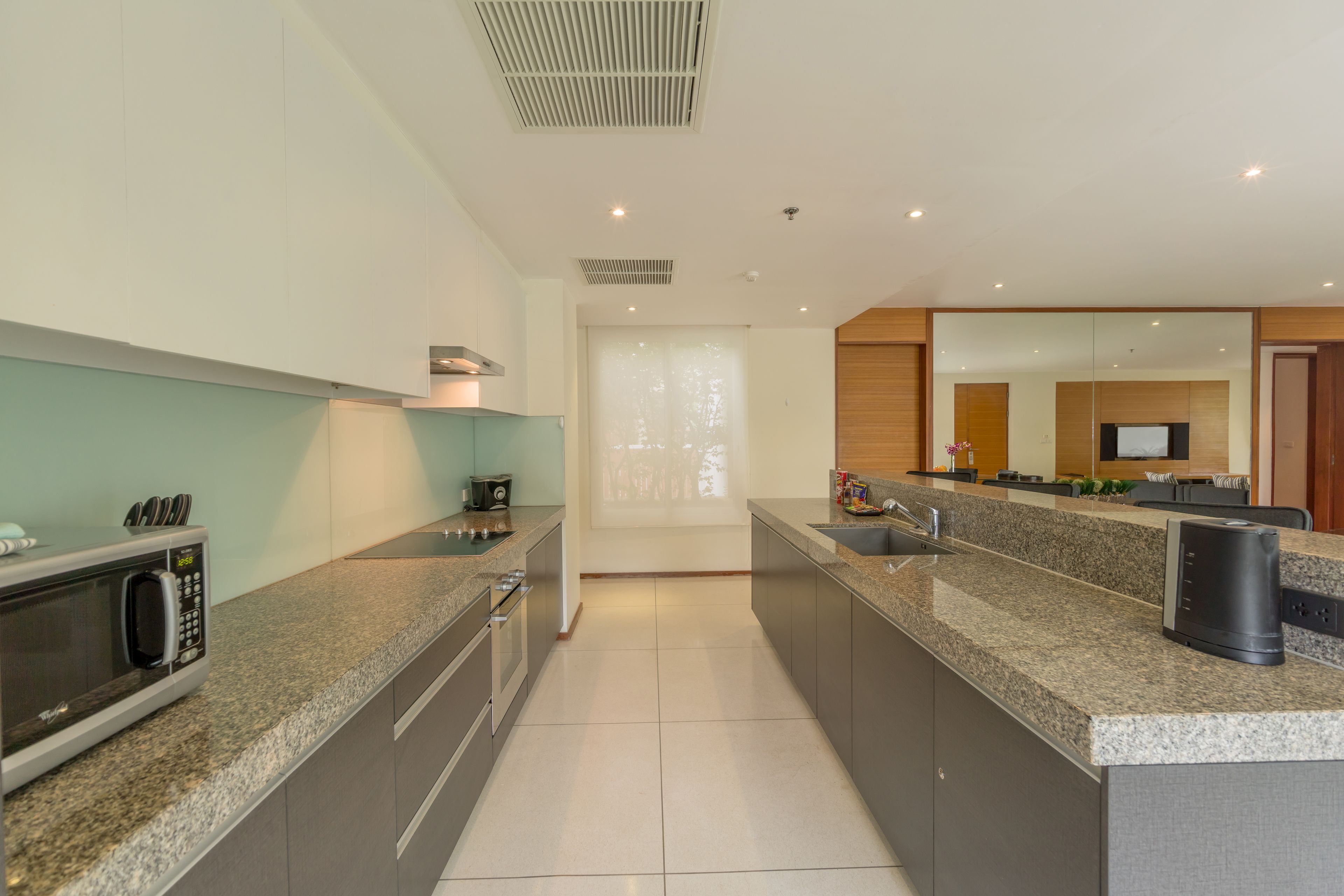 A modern kitchen with granite countertops, stainless steel appliances, and a large island.