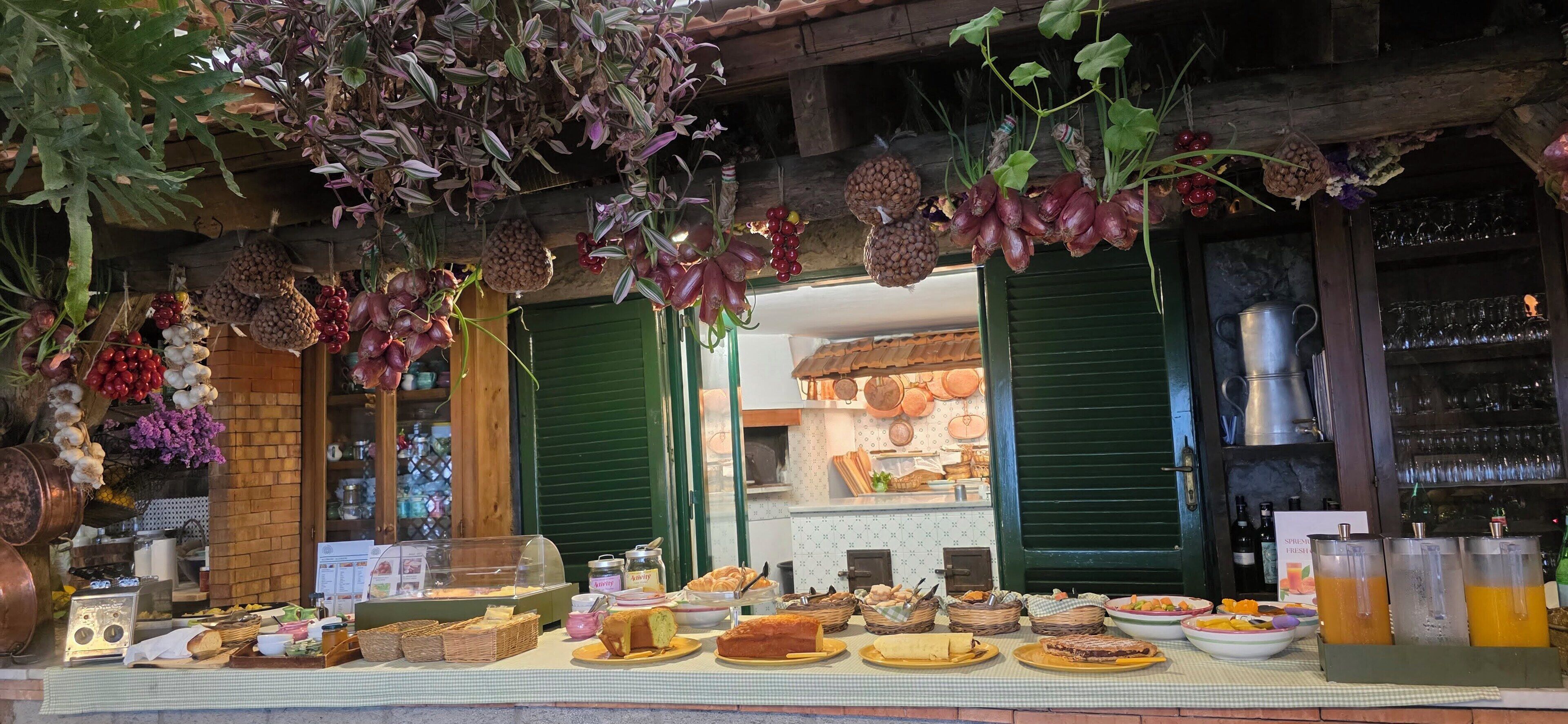 Vitrine de uma padaria com diversos produtos de panificação e um espaço para café.