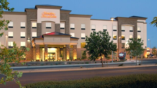 A Hampton Inn & Suites hotel with a stone facade, multiple windows, and a well-lit entrance. - Hampton Inn & Suites Prescott Valley (Prescott Valley)