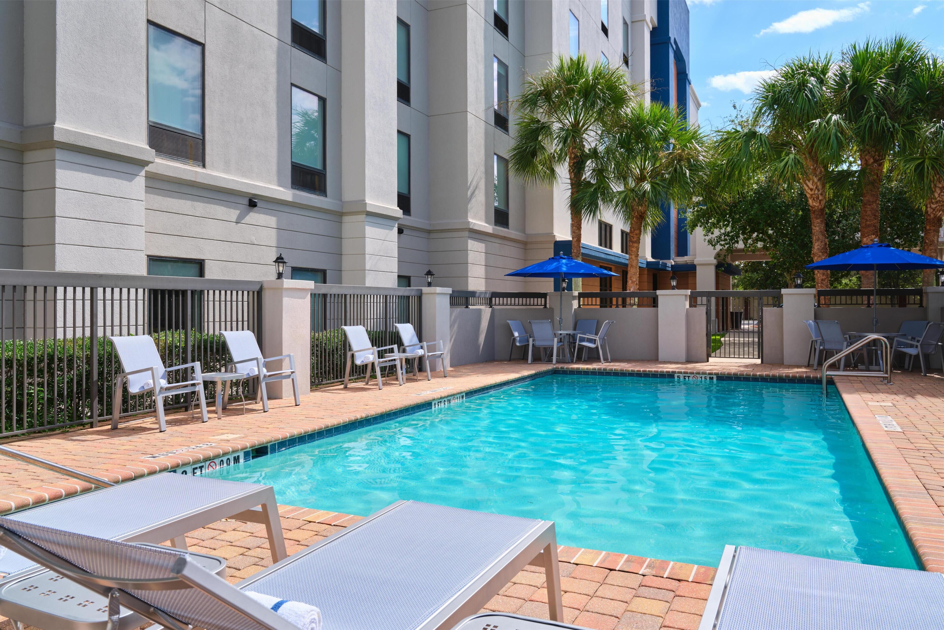 Outdoor pool, open 6 AM to 10 PM, pool loungers