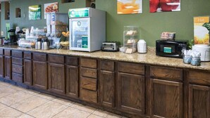 A self-service breakfast area with a coffee machine, toaster, and refrigerator. - Quality Inn Shreveport Airport (Shreveport)