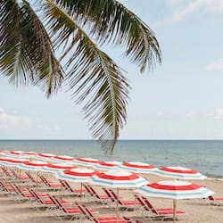 On the beach, white sand, sun loungers, beach umbrellas
