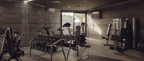 A modern gym with various exercise equipment, including treadmills, dumbbells, and weight machines.