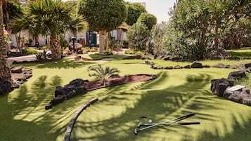Play a round of mini-golf amidst lush tropical surroundings and challenging obstacles.