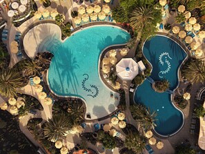 An aerial view of a resort with multiple swimming pools, sun loungers, and umbrellas. - Seaside Los Jameos (Tías)