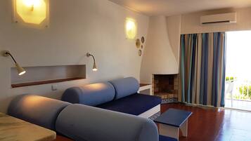 Studio, Sea View | Living area | 36-cm LCD TV with cable channels, TV