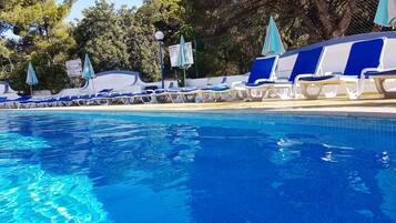 Outdoor pool, open 9:00 AM to 8:00 PM, pool umbrellas, pool loungers